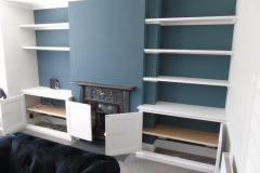 Alcove units either side of chimney breast with shelving